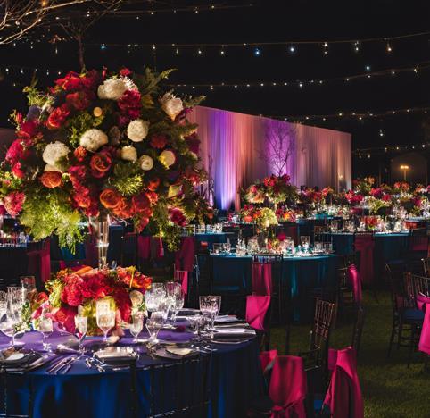 Gala tables with tall red floral centerpieces